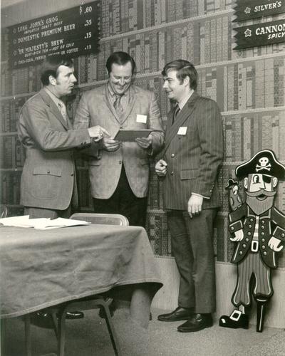 Groups; Unidentified; Two men being presented with an award by a Long John Silver's representative