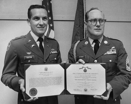 Digman, Robert D., Professor, ROTC Program, Master Sergeant, United States Army, pictured receiving the Army's Meritorious Service Award on the occasion of his retirement after more than 20 years of service, Major James G. Coston (left) presents the award