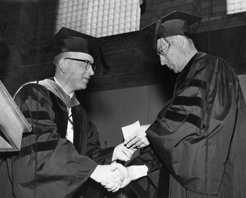 Doll, Elvis Roger, Professor, Veterinary Science, 1943 - 1967, pictured at right receiving Alumni Award for research, presented by Ralph J. Angelucci, alumni member of Board of Trustees, June 1958, Public Relations Department