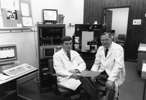 Ehmann, William D., Professor, Chemistry Department, pictured (right) with Markesbery, William R., Director of Sanders Brown Research on Aging