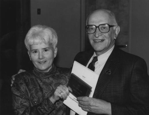 Gaines, John R., Member of Board of Trustees, 1975 - 1978 Photographer: Public Relations, pictured receiving Public Service Award from Bess Wilson, President of Friends of Kentucky Libraries, featured in March 26, 1992 