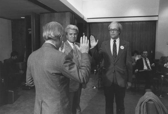 Griffin, George W., Member of Board of Trustees, 1968 - 1981; 1983 - 1989 pictured (center) taking oath of office with unknown individual