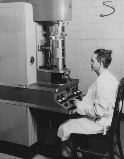 Hamilton, Dr. Brooks, Using an Electron Microscope, Photographer: W.E. Sutherland, Public Relations Department