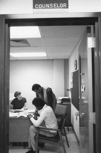 Hanley, Alvin C., Director of Minority and Disadvantaged Recruitment, in the counselor's office at Valley High School, with a student and a counselor, Louisville 1978