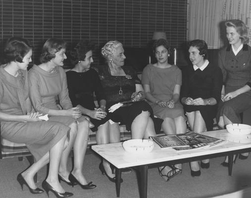 Holmes, Sarah Bennett, born 1886, University of Kentucky Dean of Women 1944-1957, She disscuses various phases of dormitory life at Holmes Hall with several residents, Left to Right are: Mary Otis Howell, Hodgenville; George Ann McGinley, Bowling Green; Mrs. Holmes; Sylvia Norris, Pikeville; Sue Harrollson, Owensboro