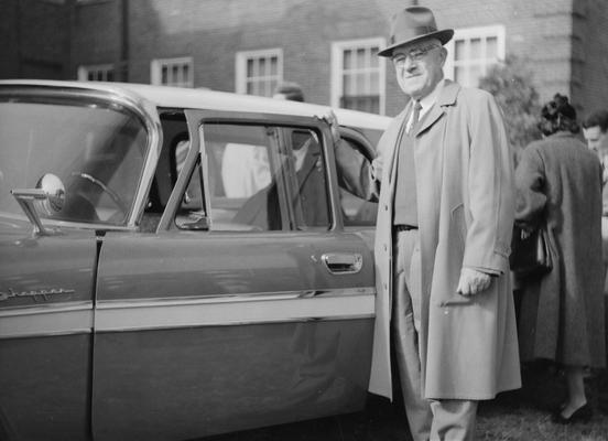 Barkman, John O., Professor, Standing beside DeSoto station wagon presented to him by former pupils, friends, and members of the dairy industry, upon his retirement from UK