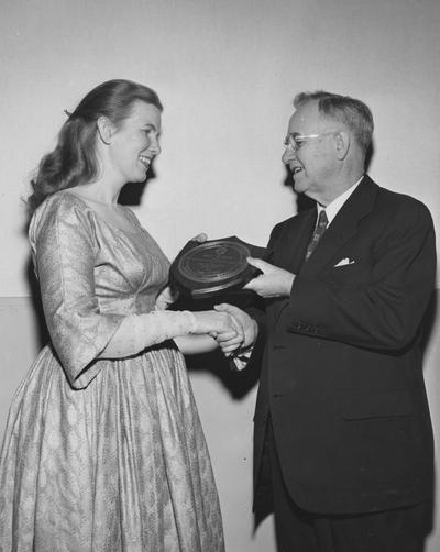 Ritchie, Jean, University of Kentucky Graduate, Folk Singer, President H.L. Donovan is presenting Ritchie with the school's first Founder's Day Award