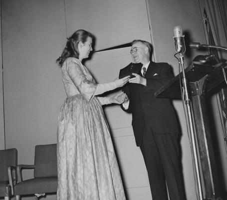 Ritchie, Jean, University of Kentucky Graduate, Folk Singer, President H. L. Donovan is presenting Ritchie with the school's first Founder's Day Award