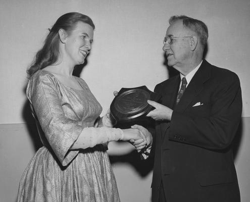 Ritchie, Jean, University of Kentucky Graduate, Folk Singer, President H. L. Donovan is presenting Ritchie with the school's first Founder's Day Award