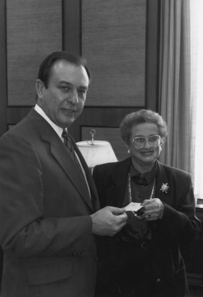 Rose, Harriet, Associate Professor of Department of Psychology, pictured presenting $1000 check to President Wethington for Commonwealth Library, from Public Relations Department, Publications Bureau