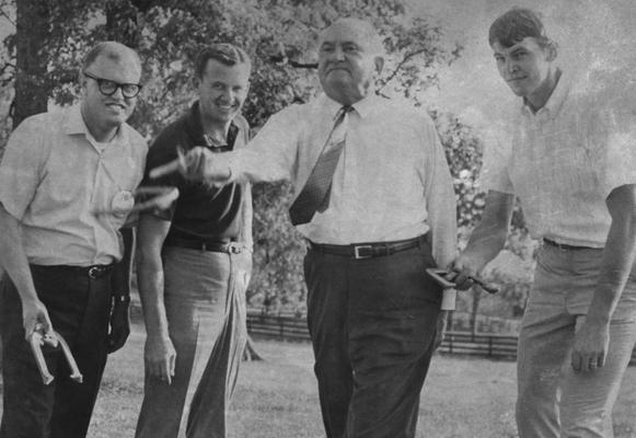 Rupp, Adolph, University of Kentucky Basketball Coach 1930-1971, committe of 101, pictured playing horseshoes, Dan Issel is pictured far right, photograph by Lexington Herald Leader Staff Photo