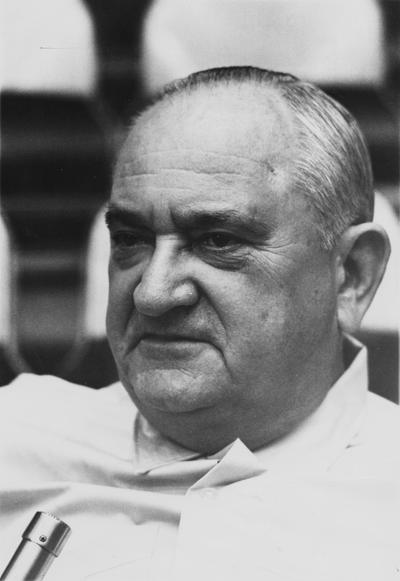 Rupp, Adolph, University of Kentucky Basketball Coach 1930-1971, pictured speaking into microphone, photograph by James N. Keen, Courier Journal and Louisville Times