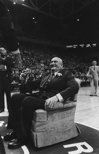 Rupp, Adolph, University of Kentucky Basketball Coach 1930-1971, presented blue chair at the University of Kentucky vs.Kansas game, dedicating Rupp Arena, University of Kentucky won 90-63, Rupp refused game ball (Rice is holding it in the background) because the 