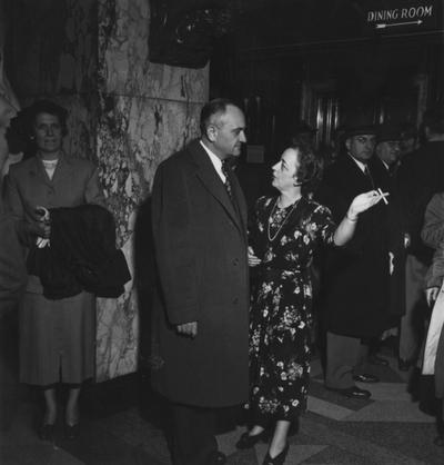 Rupp, Adolph, University of Kentucky Basketball Coach 1930-1971, conversing with Helen G. King, the University of Kentucky Director of the Alumni Association