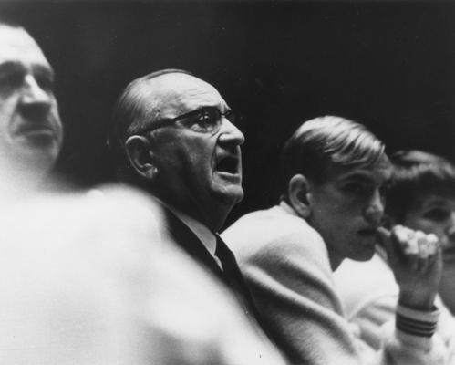 Rupp, Adolph, University of Kentucky Basketball Coach 1930-1971, pictured on bench during basketball game