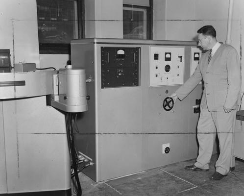 Boyer, Robert, Professor, Chemistry Department, observing new equipment, Department of Public Relations photograph, Photographer, Hack Hughes Studio