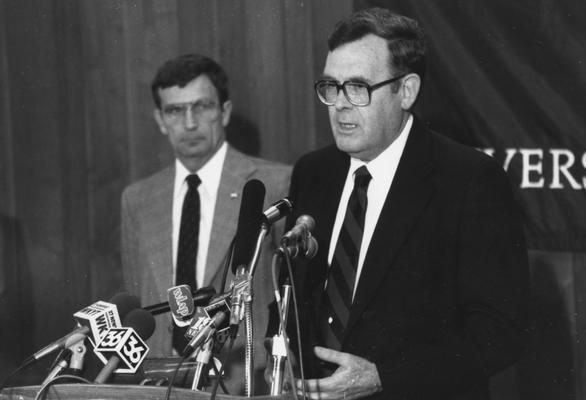 Swift, Louis, pictured speaking at a teaching portfolio news conference, pictured with Joe Davis (in background)