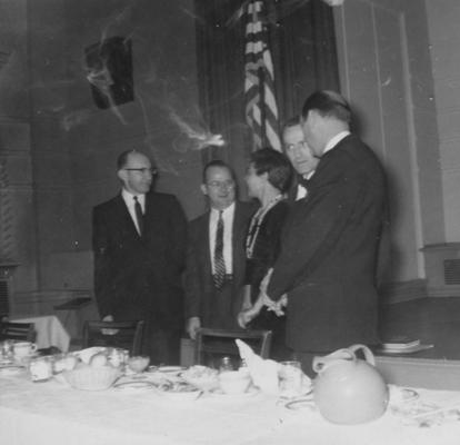 Thompson, Lawrence S., Director of Libraries 1948-1965, Professor in Classics 1965-1979, pictured speaking at a book fair dinner, Bluefield WA, pictured from left to right; H.W.Apel, Thompson, Mrs. Kermit Hunter of Jim Bean Bookseller in Ashville NC