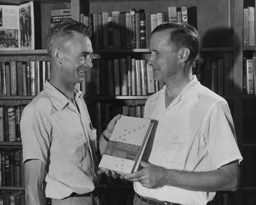 Bryan, Thomas Conn, Instructor, Department of History, 1945 - 1946, pictured (after moving to the Department of History at North Georgia College, Dahlonega) presenting a copy of his book to John H. Brendle of the Library at Fontana Village