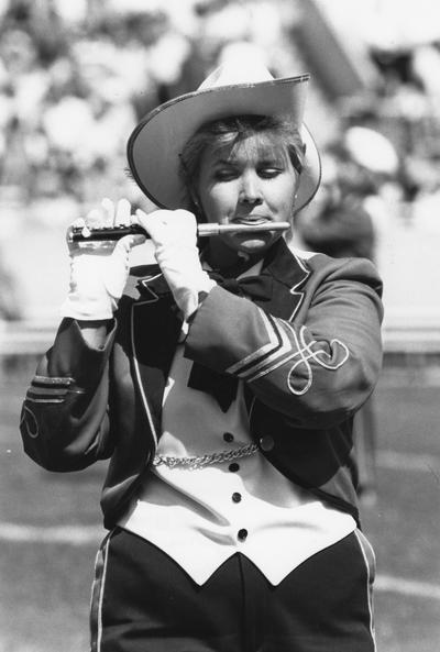 Unidentified, woman University of Kentucky band member playing the piccolo instrument in the marching band, Photographer: Ken Goad, 