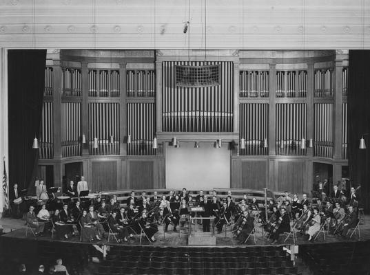 Longyear, Rey M., Musicologist, Professor, School of Music, 1964 - 1994, b. 1930 - d. 1995; pictured with Cornell University Orchestra, back left in percussion section holding timpani mallets; photograph by Maclean Dameron, Director of Photo Science Studios, Cornell University