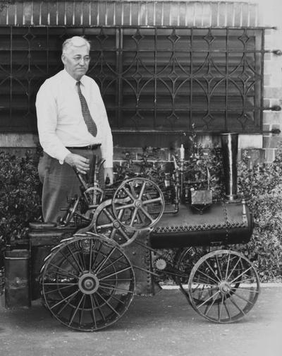 Terrell, Daniel V., Dean of Engineering with a model tractor which had been donated to the College of Engineering