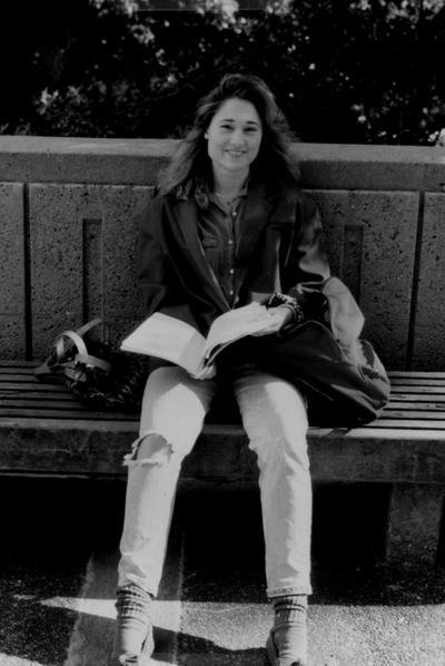 Female student, sitting on bench near Patterson Office Tower