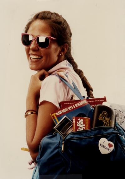 Female student posed in studio carrying a book bag