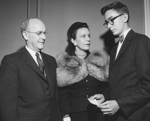 Chamberlain, Leo M., Professor, Education, University Vice President, Receiving a donation on behalf of the University from Mrs. Jack Webb, Sr. and Jack Webb, Jr., to start a loan fund for students and the College of Medicine, Public Relations Department photograph, featured in April 7, 1958 Louisville Courier - Journal