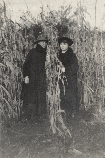 A portrait of Gertrude and an unidentified woman in a corn field. The print has a written note to Margaret Ingels on the back. This image was found pasted on the front of page 101 of 