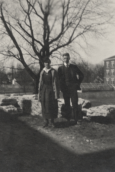 An image of Margaret Ingels and an unidentified man standing beneath a tree near some greenhouses. This image was found pasted on the front of page 103 of 