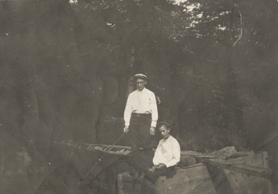 An image of Charles Christopher Schrader as a teenager with another boy fishing. There is a note on the back from Charles Christopher Schrader 