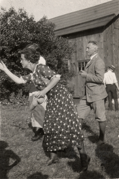 An image two men and two women outside near a barn. Margaret Ingels is in the action of throwing something. Christopher Schrader 