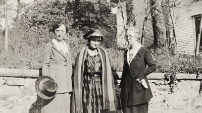 A portrait of three unidentified women in front of a stone wall. Taken by De Lure Studio, Hot Springs, Arkansas. This print was found pasted to the back of page 109 of 