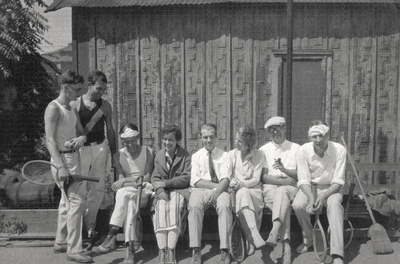 A group portrait of eight persons in tennis playing clothes and tennis rackets. Margaret Ingels is wearing a stripped skirt