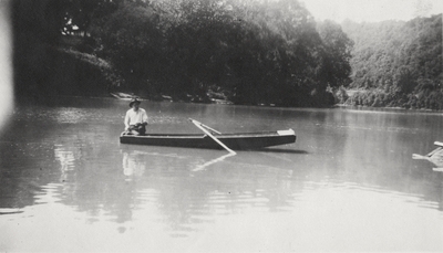An image of an unidentified man in a canoe. This print was found pasted to the front of page 113 of 