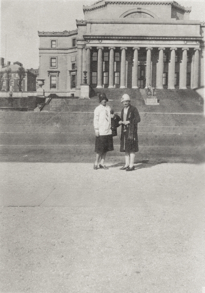 An image of two unidentified women standing in front of the Columbia University's Library