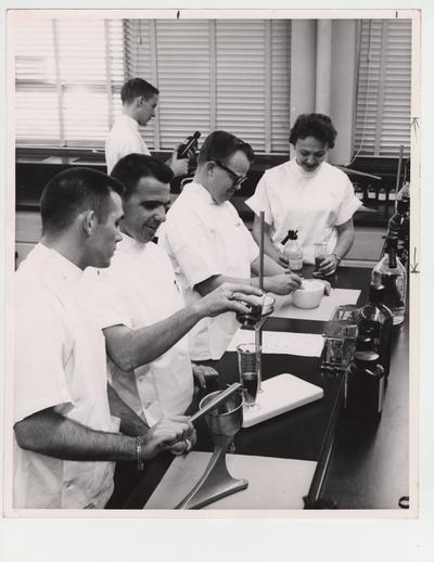 Pharmacy students conduct experiments in the lab