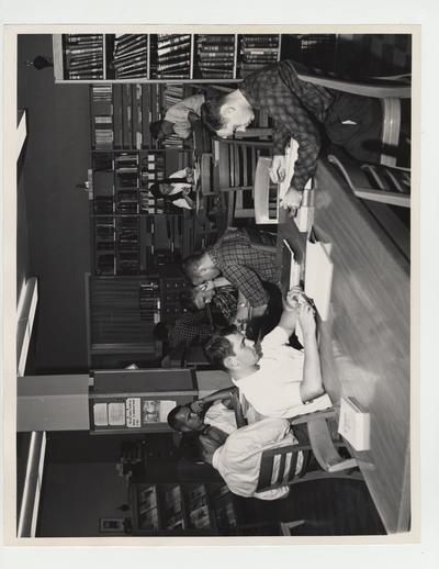 James Miller and Tommy Samuels (at table on far right) with other students studying at the Pharmacy Library