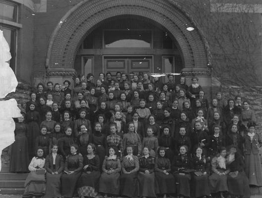 Large group photograph of unidentified women, titled Report of the Association of Alumni, 1990, page 11; gift of T. R. Bryant, July 28, 1948; taken in front of the Gillis Building (then the Chemistry and Experiment Station Building)