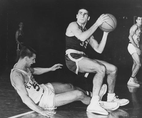 Basketball game action; unidentified player takes a shot against UK; Dick Parsons falling to the floor, left; Lexington Herald-Leader staff photo