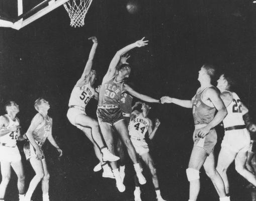 Basketball game action, UK versus Georgia Tech; pictured are Bill Evans (42), Phil Grawemeyer (44), Jerry Bird (22), and Bob Burrows (50), from the 1954-55 season; photo appears on page 134 in the 1955 Kentuckian