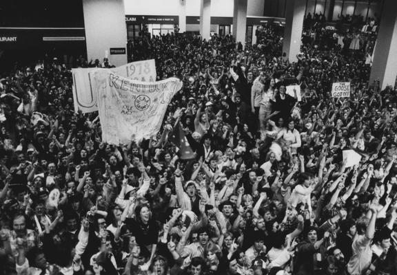Thousands of students and fans gather at Lexington's Bluegrass Field (airport) to greet the returning 1978 NCAA championship UK basketball team