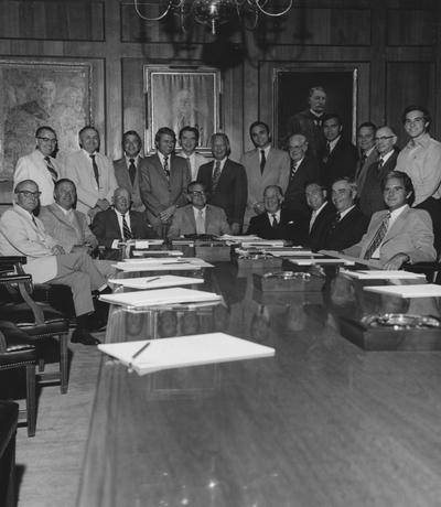 Athletics Board meeting; former governor A. B. Chandler sits to the left of University President Otis Singletary (4th from left), Cliff Hagan (standing 4th from right), Larry Forgy (standing 6th from right), Daniel Reedy (standing 3rd from left), Harry Lancaster (seated 2nd from left), and 14 other unidentified members