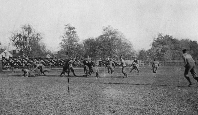 Unidentified students playing football at the Senior - Junior class game. Photo appears on page 159 in the 1912 Kentuckian