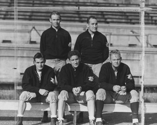UK football coaching staff, (top row,left to right) Joe Rupert, Gene Myers, (bottom row, left to right) Frank Moseley, Ab Kirwan (head coach), and Bernie Shively (Athletics Director and line coach), 1939; photo appears in the Cincinnati Enquirer with caption reading 