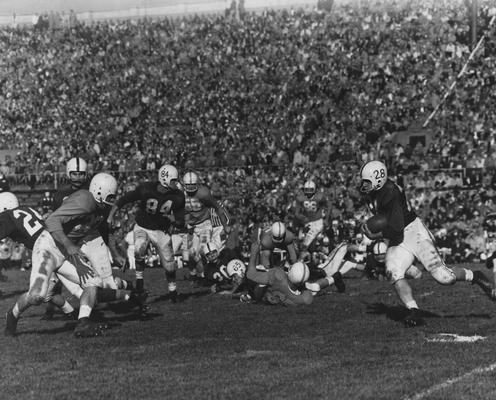 Unidentified football players during game against unidentified opponent; photographer:  University of Kentucky