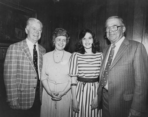 Harry Lancaster, former assistant basketball coach and former Athletics Director, pictured standing with three unidentified people