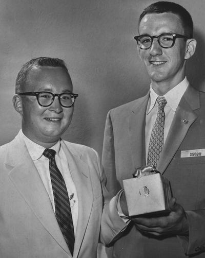 Two unidentified students holding a gift awarded for being outstanding seniors, May 25, 1957; Lexington Herald-Leader photo