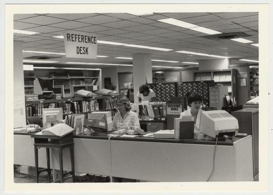 Librarians Judy Sackett (left) and Carla Cantagallo (right) at the Margaret I. King Library Reference Desk